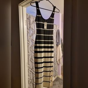 Never been worn black and white dress with side slit, in excellent condition.